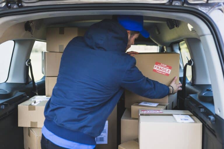 A mover is arranging boxes inside the van