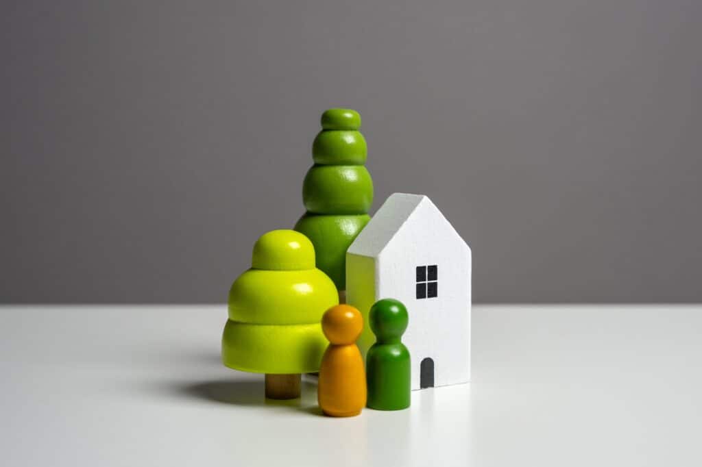 A house and people figurine in the concept of moving to Hendon and saving money.