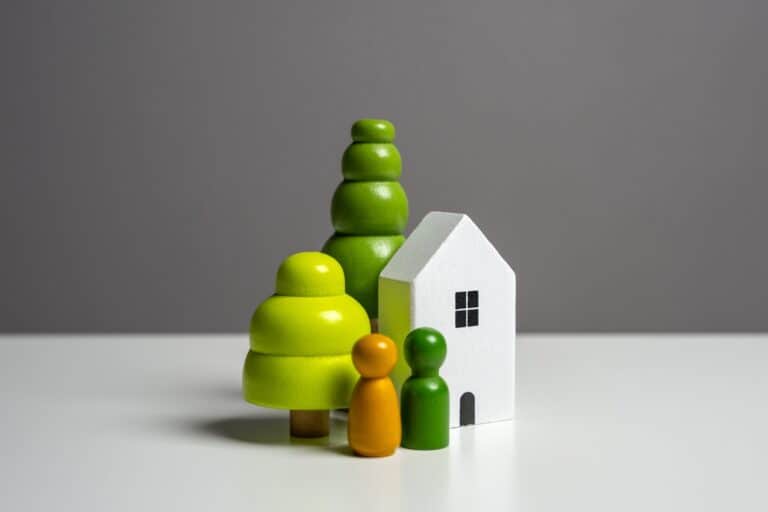 A house and people figurine in the concept of moving to Hendon and saving money.