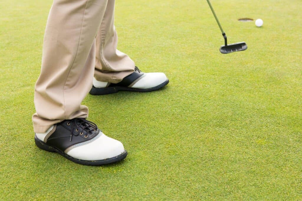 Cropped image of a golfer about to tee off
