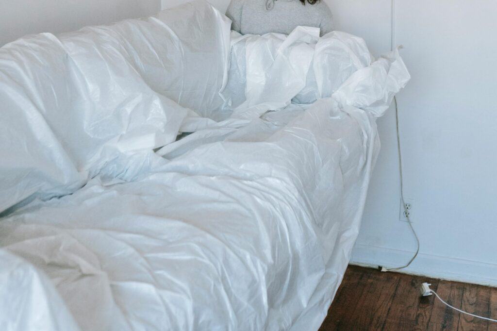 A sofa wrapped in plastic for the move
