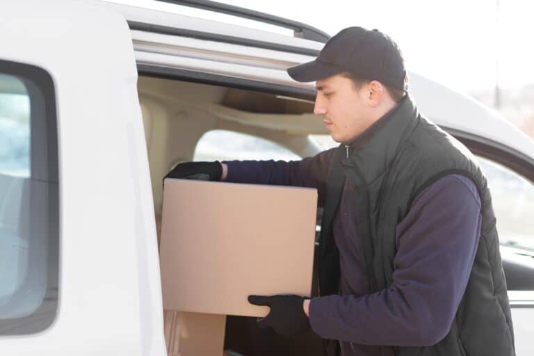 A man and van crew placing a small box into the van in the concept of 'Advantages of Using a Man and Van Service for Your Move to Hendon'.