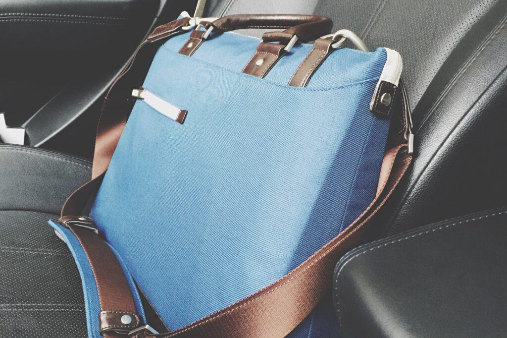A laptop bag with confidential documents in a car seat during the move