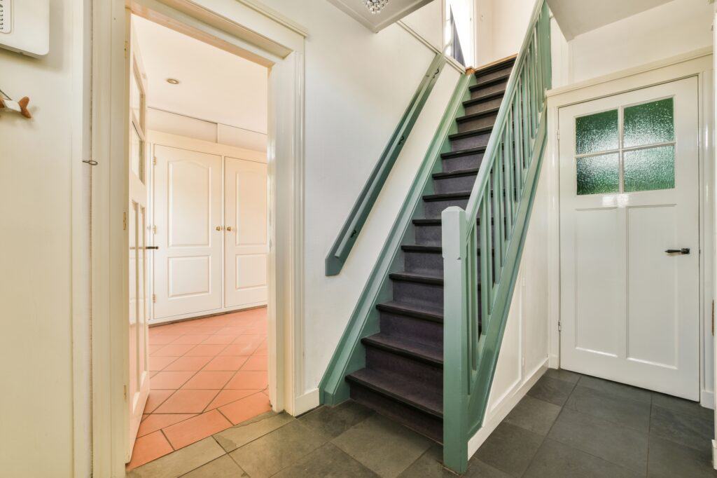 A tight green-coloured staircase -  challenging access for a Man and Van