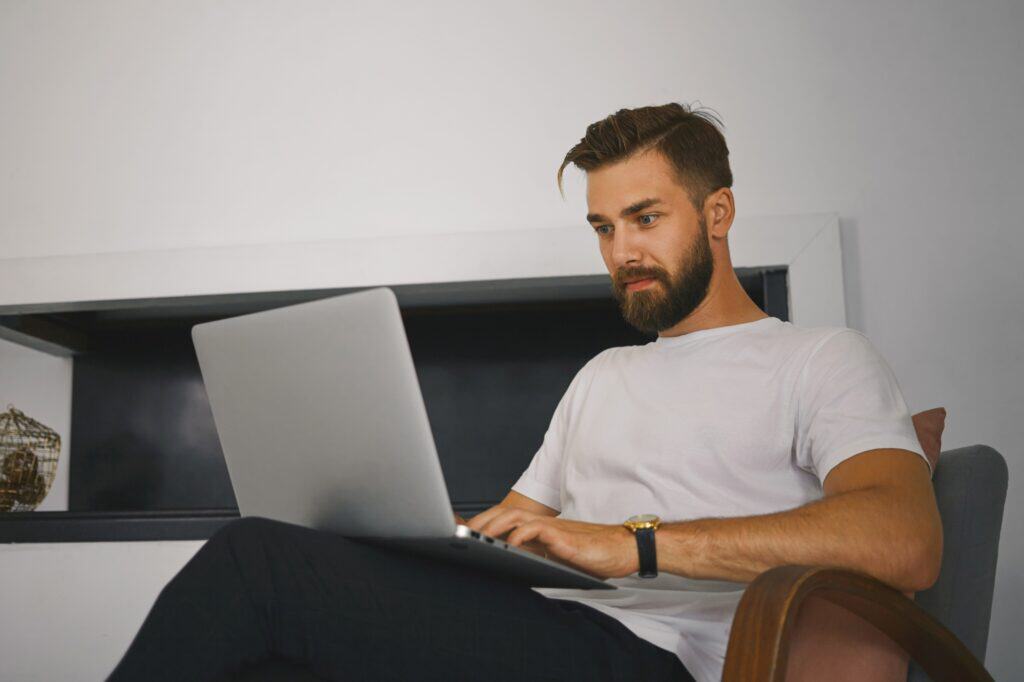 A man getting quotes from a man and van in his laptop